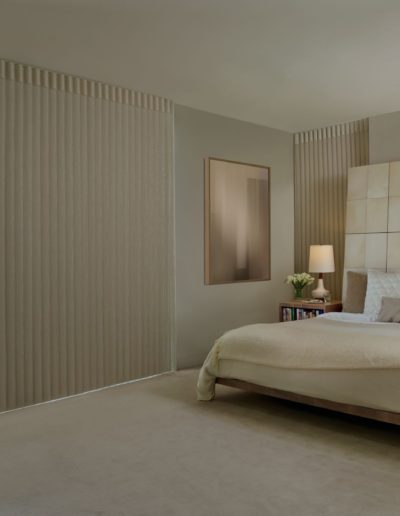 Modern bedroom with beige pull shades