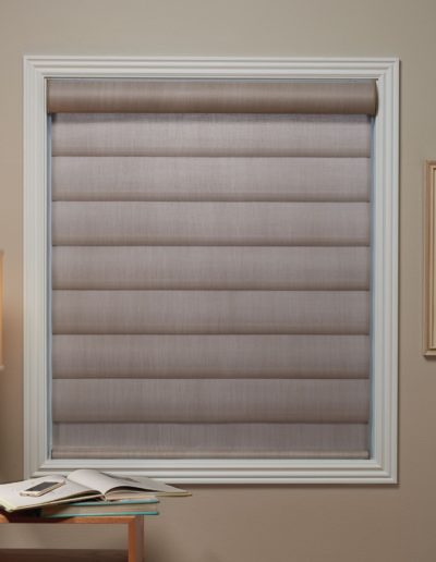 Light gray sheers covering white trimmed window