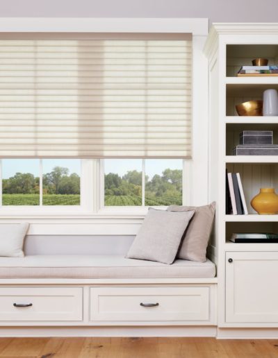 White honeycomb blinds in a reading nook